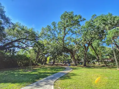 a path in a park with trees and grass at Flamingo Place - One block to Lauderdale Marine Center - 3 bedroom - 2 bath - King bed in Fort Lauderdale