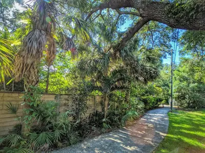 a path in a park with trees and a fence at Flamingo Place - One block to Lauderdale Marine Center - 3 bedroom - 2 bath - King bed in Fort Lauderdale