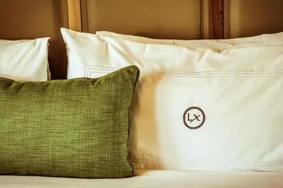 a bed with white pillows and a pillow with a no smoking sign at Lennox Miami Beach in Miami Beach