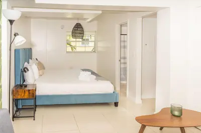 a bedroom with a bed and a table at Miami River Inn by Renzzi in Miami