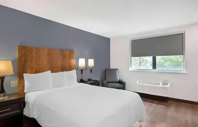 a bedroom with a bed and a chair and a window at Extended Stay America Premier Suites - Miami - Downtown Brickell - Cruise Port in Miami
