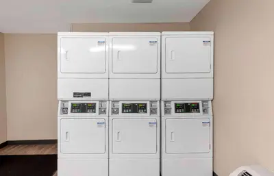 a group of four machines stacked against a wall at Extended Stay America Premier Suites - Miami - Downtown Brickell - Cruise Port in Miami