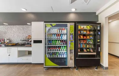 a soda machine in a kitchen next to a counter at Extended Stay America Premier Suites - Miami - Airport - Doral - 25th Street in Miami