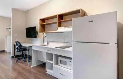 a kitchen with a white refrigerator and a desk at Extended Stay America Premier Suites - Miami - Airport - Doral - 25th Street in Miami