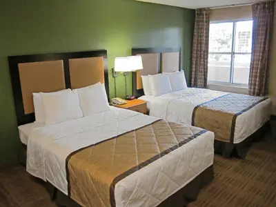a hotel room with two beds and a window at Extended Stay America Suites - Fort Lauderdale - Davie in Davie