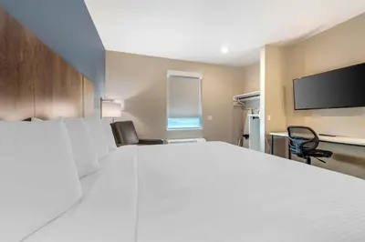a large white bed in a room with a tv at Extended Stay America Suites - Fort Lauderdale - Plantation in Plantation