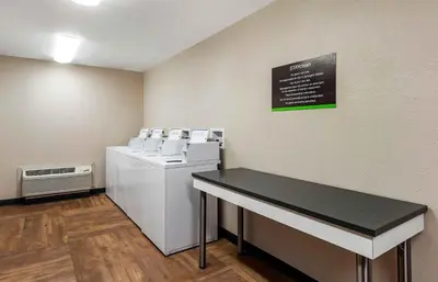 a laundry room with white machines and a black counter at Extended Stay America Suites - Fort Lauderdale - Plantation in Plantation