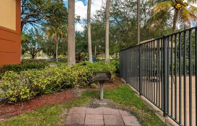 a park with a fence and a sign in the grass at Extended Stay America Suites - Fort Lauderdale - Plantation in Plantation
