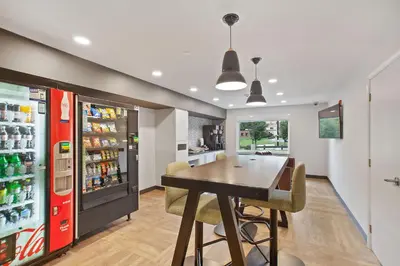 a dining room with a table and a refrigerator at Extended Stay America Suites - Fort Lauderdale - Plantation in Plantation