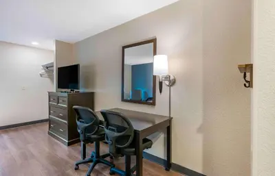 a room with a desk and chairs and a mirror at Extended Stay America Premier Suites - Miami - Coral Gables in Miami