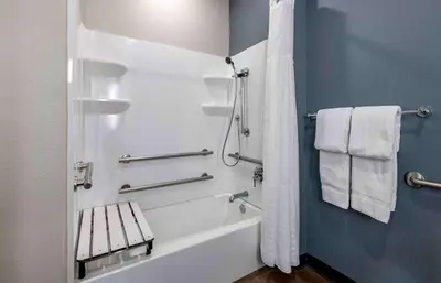 a bathroom with a tub and a shower with towels at Extended Stay America Premier Suites - Miami - Coral Gables in Miami
