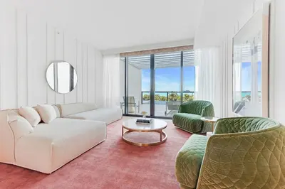 a living room with a couch and chairs and a table at W South Beach in Miami Beach