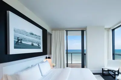 a hotel room with a bed and a view of the ocean at W South Beach in Miami Beach