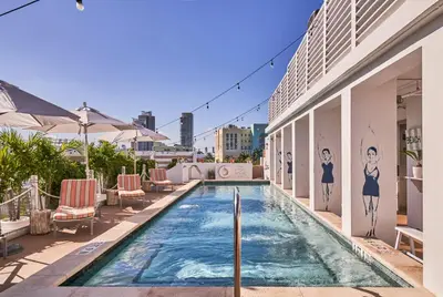 a swimming pool on the roof of a building at The Local House in Miami Beach