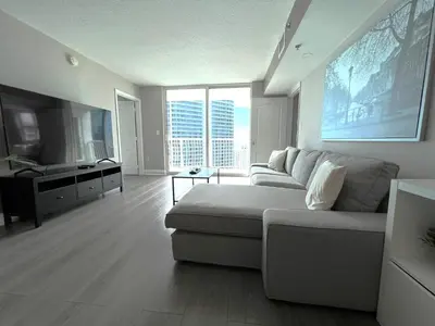 a living room with a couch and a large window at Great 2 Bedrooms in Brickell in Miami