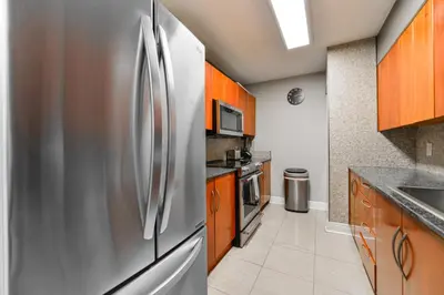 a stainless steel refrigerator in a kitchen with wooden cabinets at Great 2 Bedrooms in Brickell in Miami
