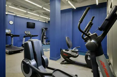 a gym with several cardio machines in a blue wall at Aloft Miami Doral in Miami