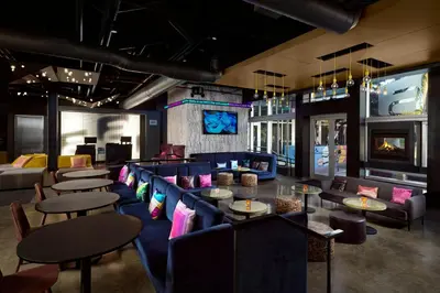 a restaurant with couches and tables and chairs at Aloft Miami Doral in Miami