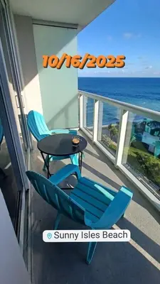 a balcony with two chairs and a table and the ocean at Miami Direct Access to the beach in Miami Beach