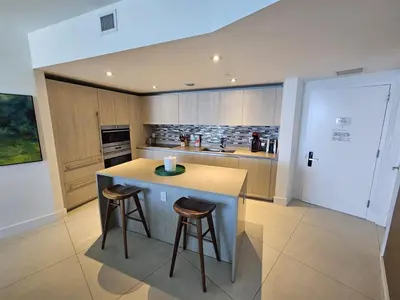 a kitchen with a counter and two stools in it at Lyfe-3308 in Hollywood