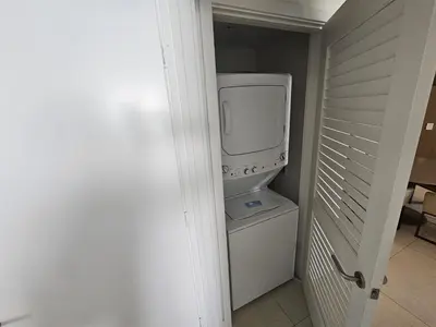 a bathroom with a washer and dryer in a room at Lyfe-3308 in Hollywood