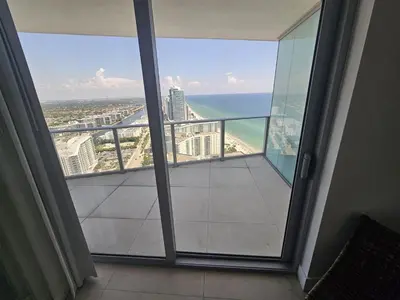a balcony with a view of the beach and ocean at Lyfe-3308 in Hollywood