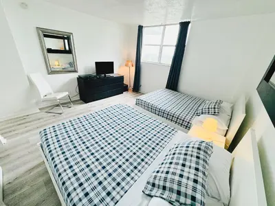 a bedroom with two beds and a mirror at Miami Hollywood Condo With Pool and Partial Ocean View 003-21mar in Hollywood