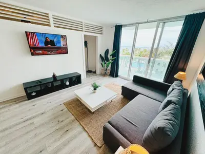 a living room with a couch and a tv at Miami Hollywood Condo With Pool and Partial Ocean View 003-21mar in Hollywood