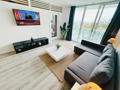 a living room with a couch and a tv at Miami Hollywood Condo With Pool and Partial Ocean View 003-21mar in Hollywood