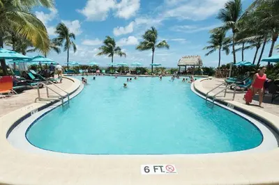 a swimming pool at a resort with people in it at Miami Hollywood Condo With Pool and Partial Ocean View 003-21mar in Hollywood