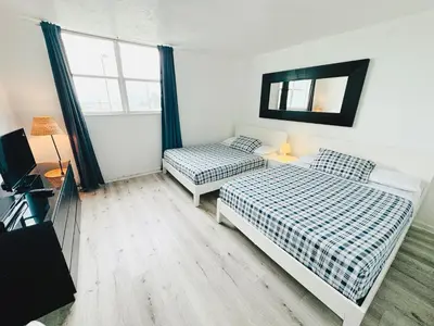 a bedroom with two beds and a television in it at Miami Hollywood Condo With Pool and Partial Ocean View 003-21mar in Hollywood