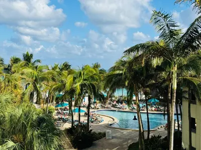 a view of a resort pool with palm trees at Miami Hollywood Condo for 4 People 001-21vic in Hollywood