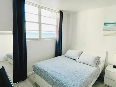 a small bedroom with a bed and a window at Miami Hollywood Condo 2BD With Ocean View 005-21mar in Hollywood