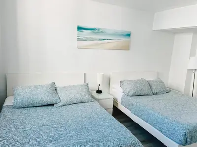 a bedroom with two beds and a painting on the wall at Miami Hollywood Condo 2BD With Ocean View 005-21mar in Hollywood
