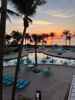 a view of a pool with palm trees and a sunset at Miami Hollywood Condo 2BD With Ocean View 005-21mar in Hollywood