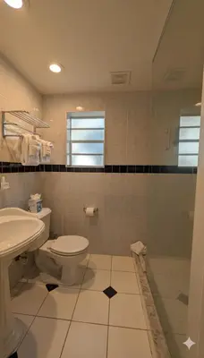 a bathroom with a toilet and a sink at La Casa Hotel in Fort Lauderdale