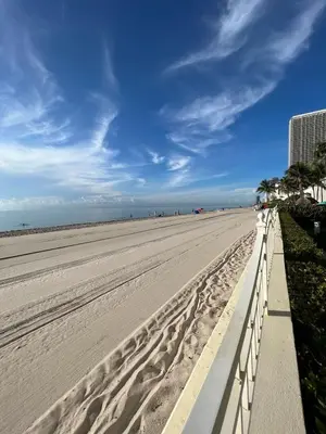 a sandy beach with a white fence and palm trees at Miami Hollywood Incredible 2 Bedroom 2 Bathroom 005-22bmar in Hollywood