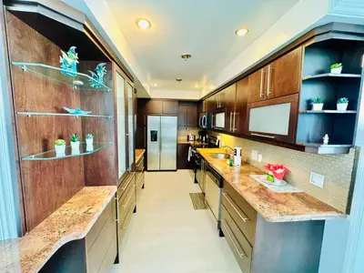 a large kitchen with wooden cabinets and counters at Miami Hollywood Incredible 2 Bedroom 2 Bathroom 005-22bmar in Hollywood