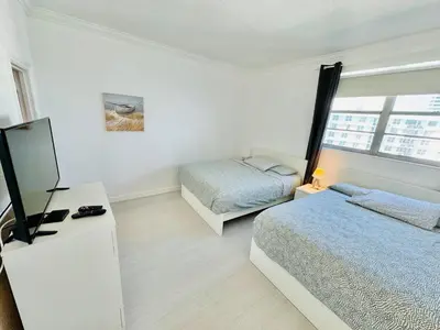a bedroom with two beds and a television in it at Miami Hollywood Incredible 2 Bedroom 2 Bathroom 005-22bmar in Hollywood