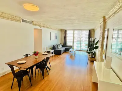 a living room with a table and a couch at Hallandale Beach Partial Ocean View Apartments in Hollywood