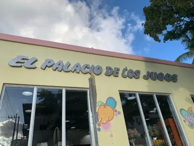 a restaurant with a sign on the side of it at Luxury white loft on Ocean Drive-South beach with a view in Miami Beach