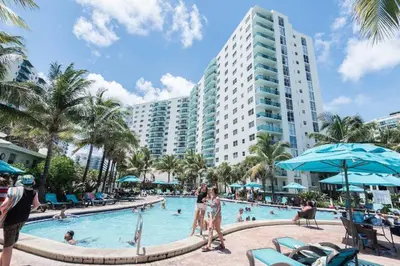 a pool at a resort with people in it at Hallandale Beach Intracoastal View Apartments in Hollywood