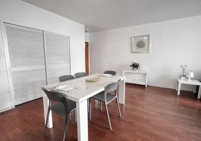 a white dining room with a white table and chairs at Hallandale Beach Intracoastal View Apartments in Hollywood