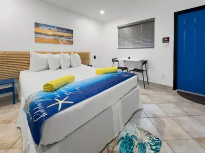 a bedroom with a large bed and a tv at Hollywood Sunrise in Hollywood