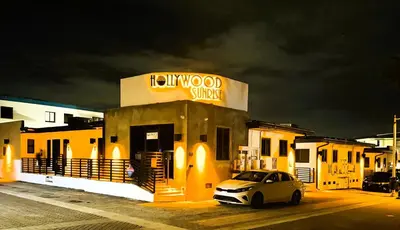 a car parked in front of a building with a sign at Hollywood Sunrise in Hollywood