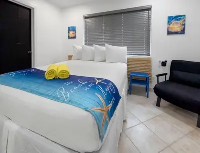 a bedroom with a bed with two yellow shoes on it at Hollywood Sunrise in Hollywood