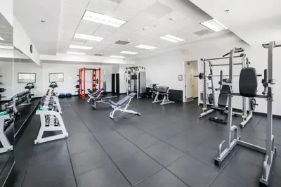 a gym with treadmills and machines in a room at Miami Downtown City view 3BR Air Hockey &Ping Pong table in Miami