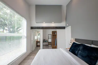 a bedroom with a white bed and a large window at The Lauderdale Boutique Hotel in Fort Lauderdale