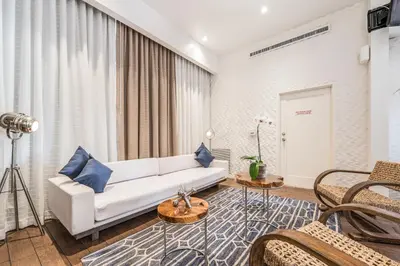 a living room with a white couch and blue pillows at The Landon Bay Harbor-Miami Beach in Miami Beach