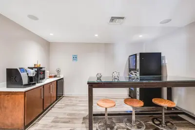a kitchen with a table with stools and a microwave at The Landon Bay Harbor-Miami Beach in Miami Beach